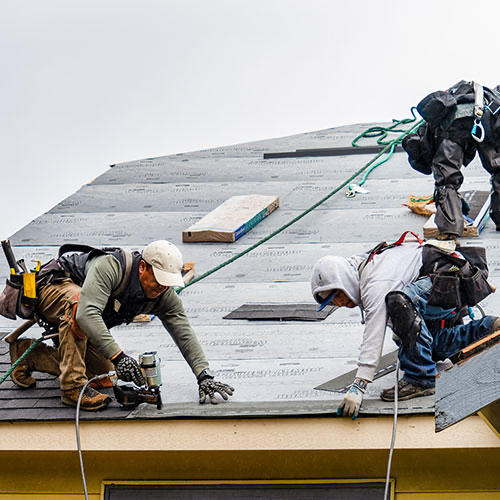 Roof repair Oklahoma City crew working together on a residential roof